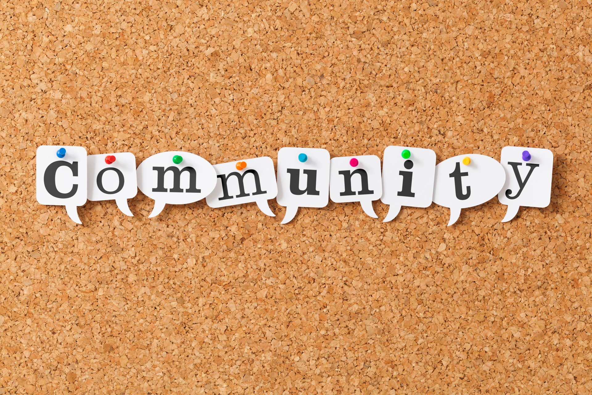 Community on speech bubbles pinned to notice board